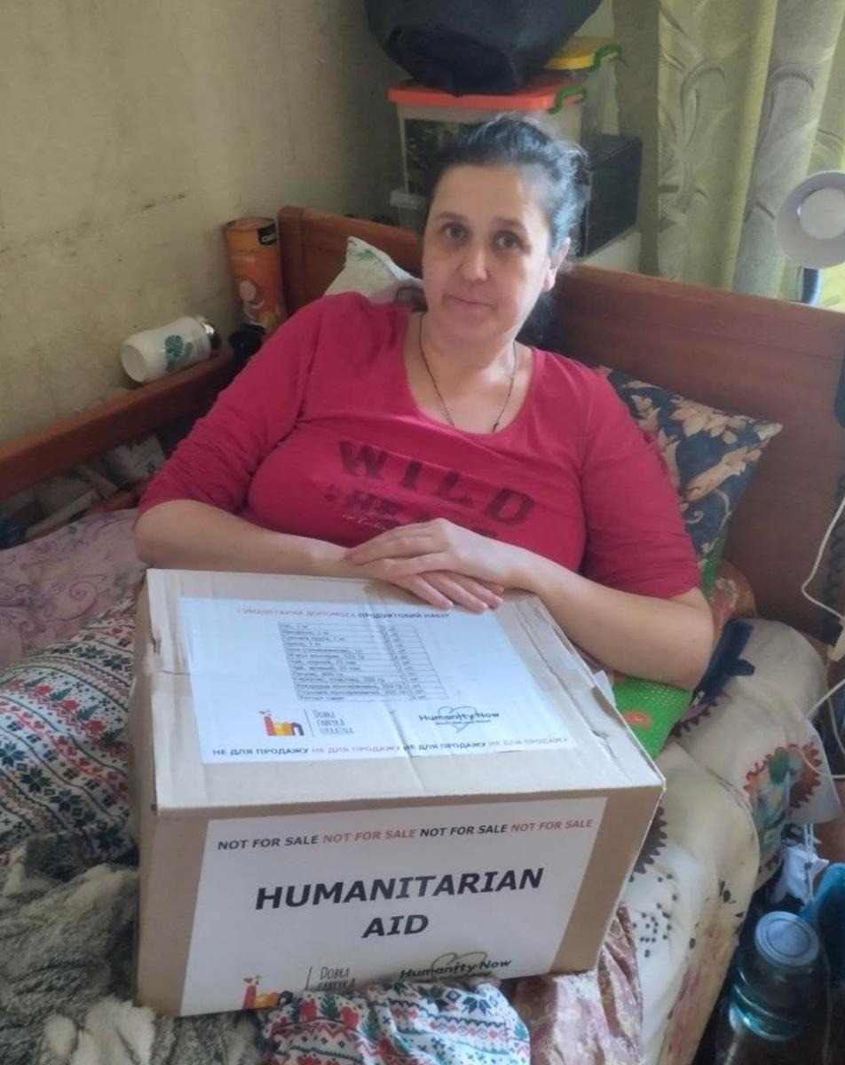 Homebound woman with food distribution box